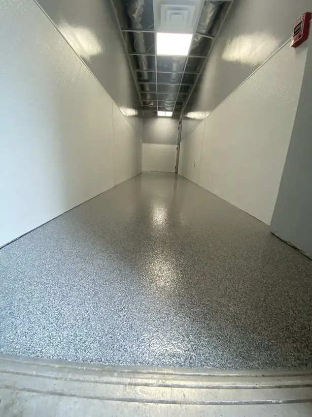Main corridor — flake broadcast with a high-gloss clear coat — epoxy flake flooring by Vibrant Painting, Greenville SC