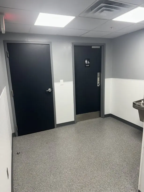 Restroom entry — floor, doors, and walls finished together — epoxy flake flooring by Vibrant Painting, Greenville SC