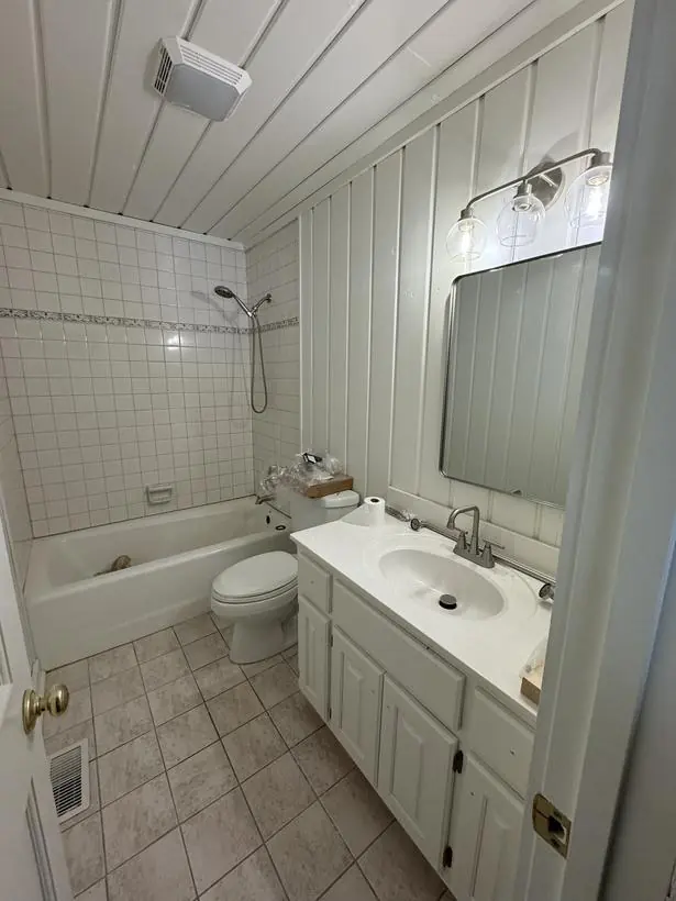 Full bath — paneling, ceiling, and vanity — lakefront home repaint by Vibrant Painting, Greenville SC