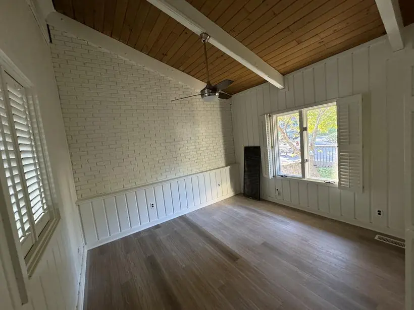 Bedroom — painted brick with natural wood ceiling — lakefront home repaint by Vibrant Painting, Greenville SC