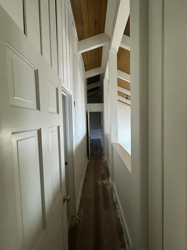 Hallway — walls, doors, and exposed beams — lakefront home repaint by Vibrant Painting, Greenville SC