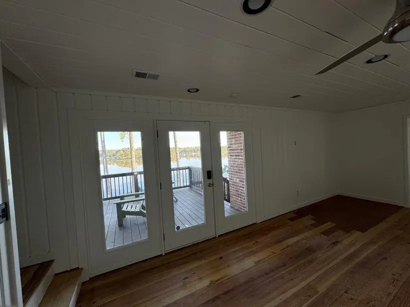 Lakeside room — board & batten walls, refinished floors — lakefront home repaint by Vibrant Painting, Greenville SC