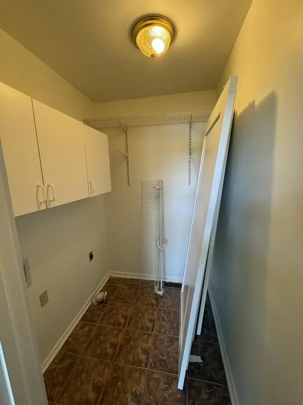 Loft overlook — rails, brick, and beamed ceiling — lakefront home repaint by Vibrant Painting, Greenville SC