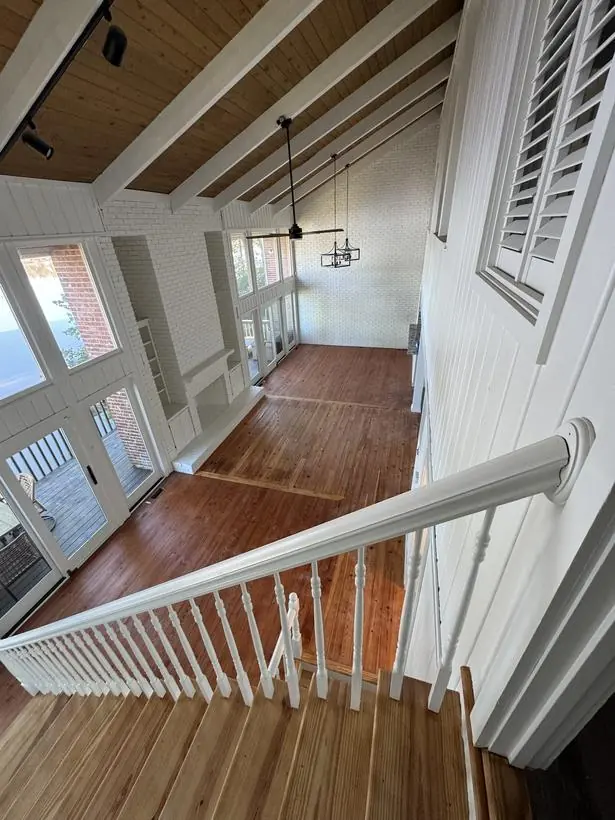 Staircase & landing — rails, risers, and painted brick — lakefront home repaint by Vibrant Painting, Greenville SC